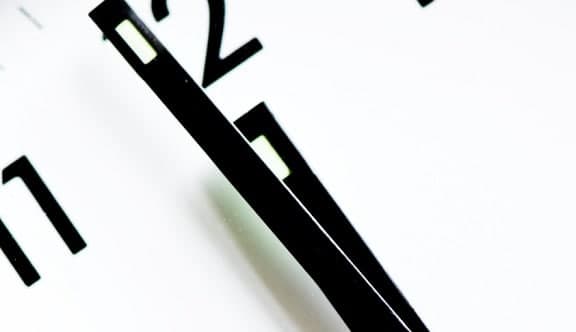 A clock face showing 11.59