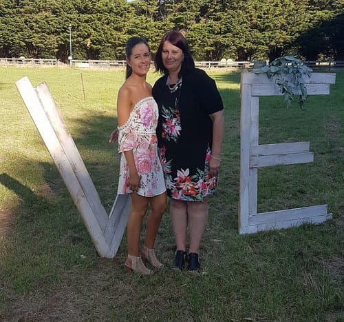 Diane and her daughter pose on a lawn together