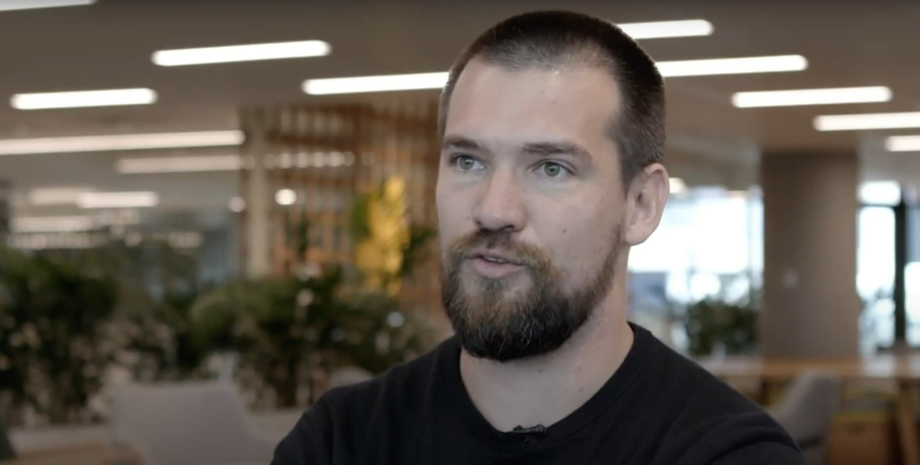 Henry sitting in an office looking at the camera