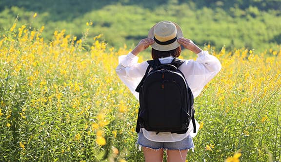 A woman enjoys a field of flowers