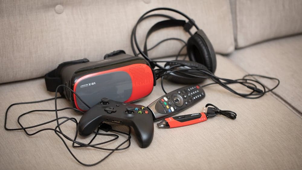 A vape that looks like a USB stick next to gaming equipment