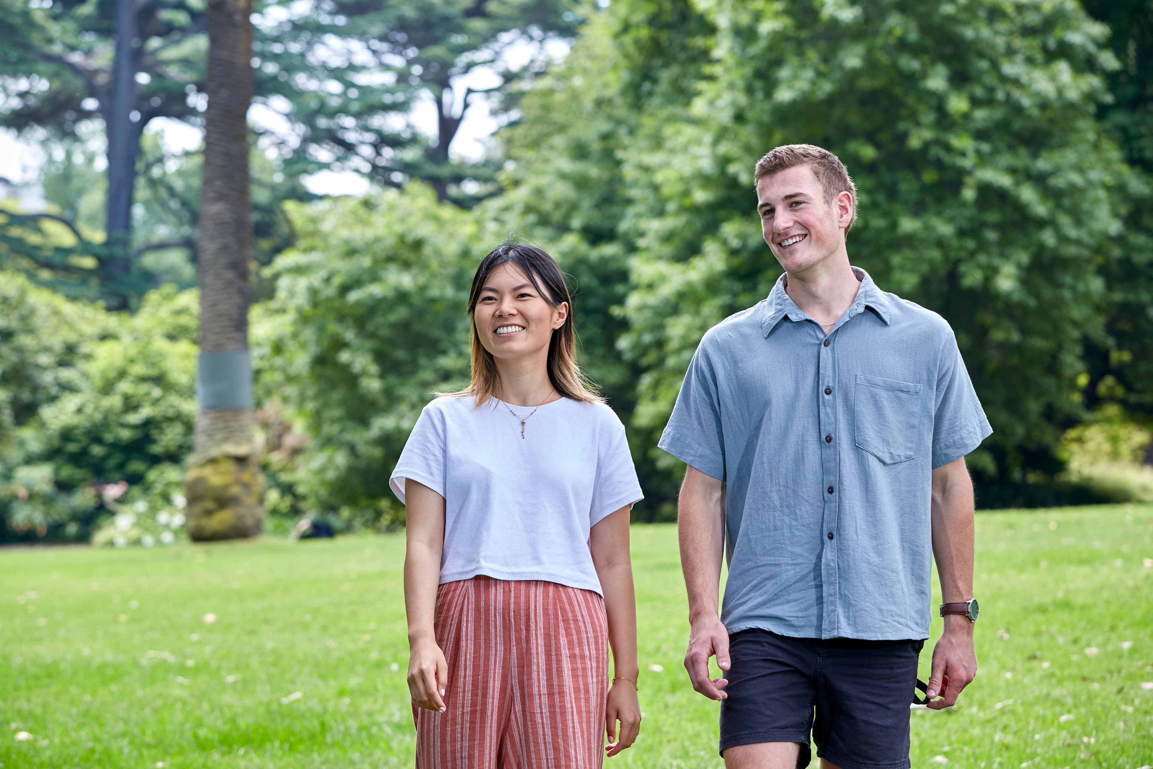 Two people walking in a park