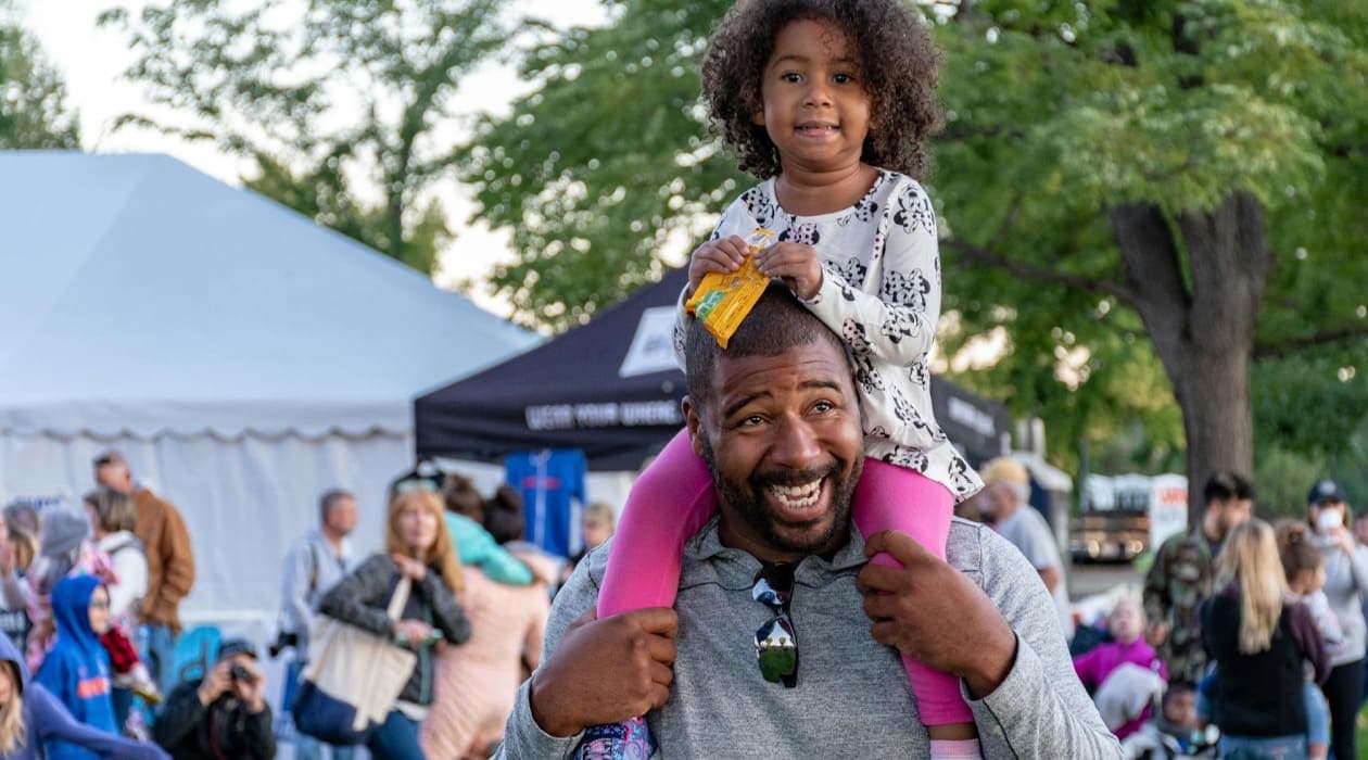 Father with his daughter on his shoulders
