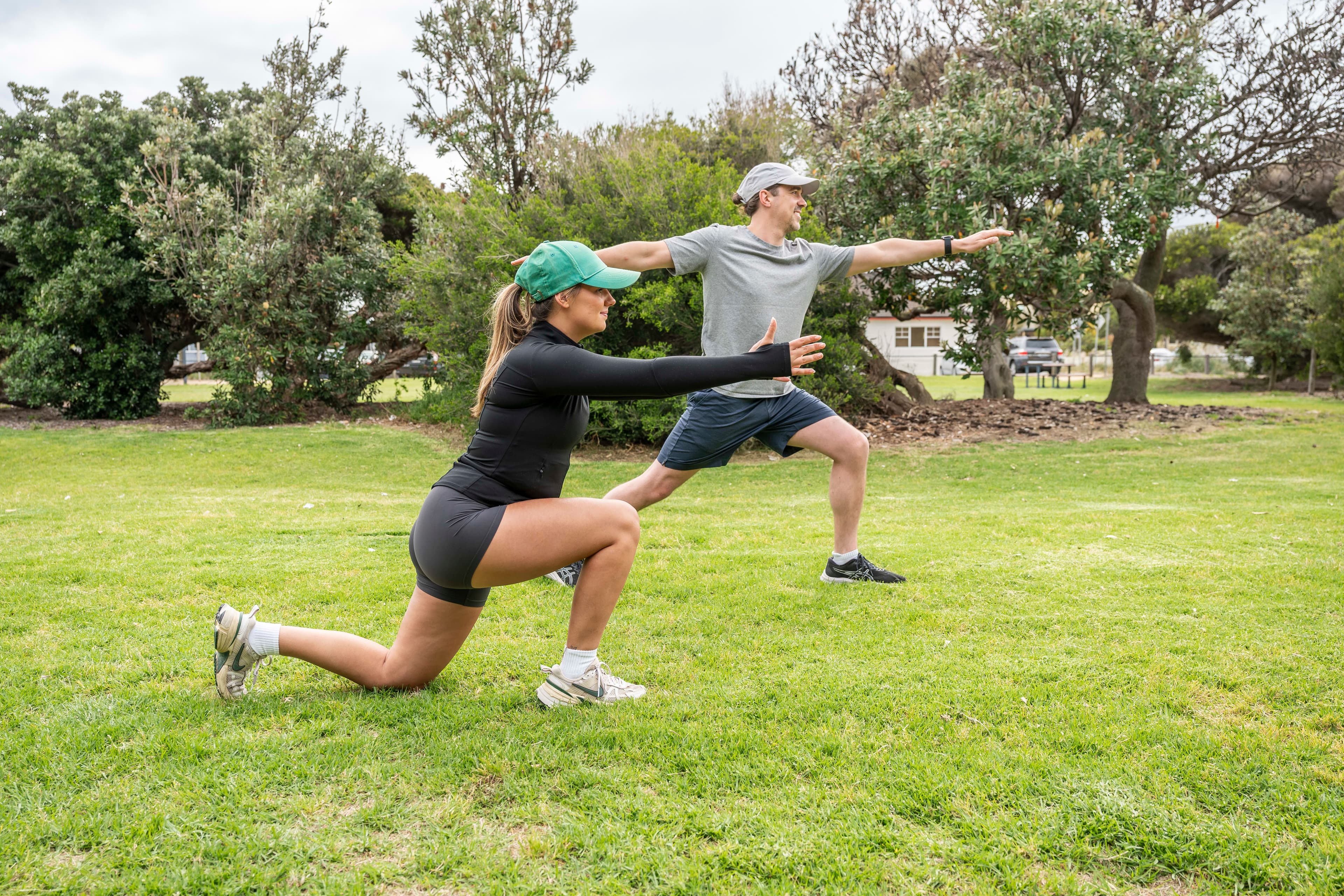 Two people exercise outdoors