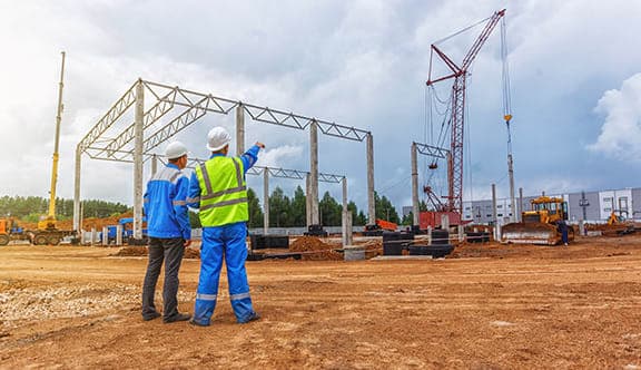 Men at a construction site inspect work