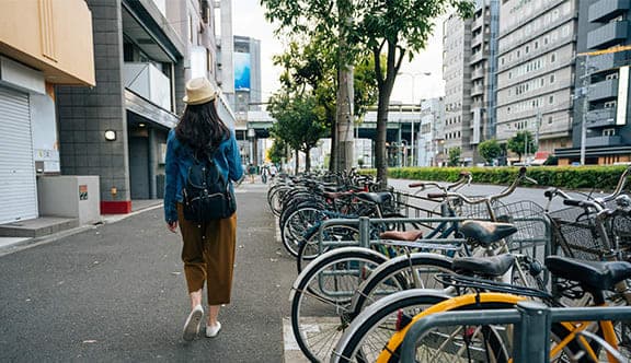 A woman walks down a city road