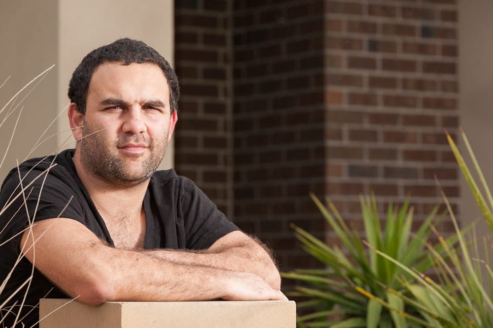 A man in a dark shirt looks out