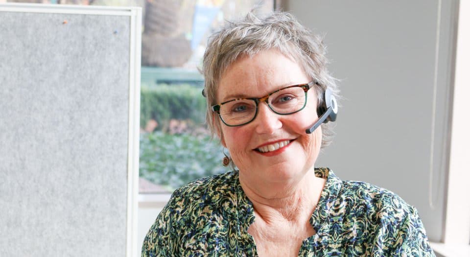 Woman with headset smiling at camera